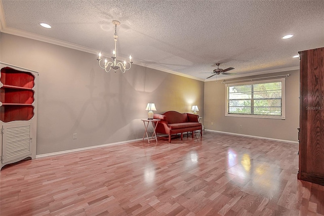 living area featuring baseboards, light wood-style floors, ornamental molding, and a textured ceiling