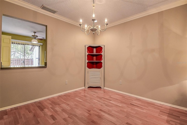 unfurnished room with a notable chandelier, a textured ceiling, crown molding, and wood finished floors