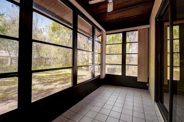 unfurnished sunroom featuring a ceiling fan