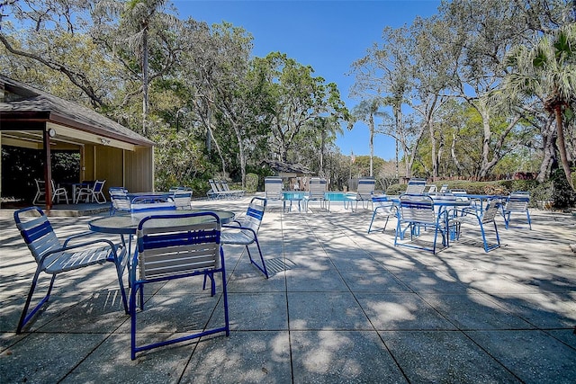 view of patio / terrace featuring outdoor dining space and a community pool