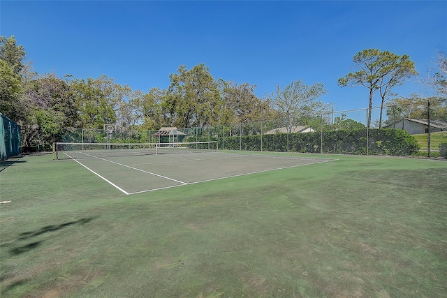 view of tennis court with fence