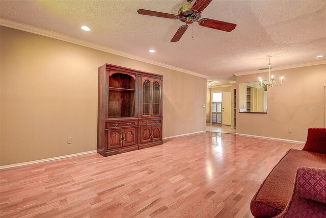 4031 Bluff Oak Ct, Palm Harbor, FL 34684 - living area with light wood-type flooring, baseboards, a textured ceiling, and ceiling fan with notable chandelier