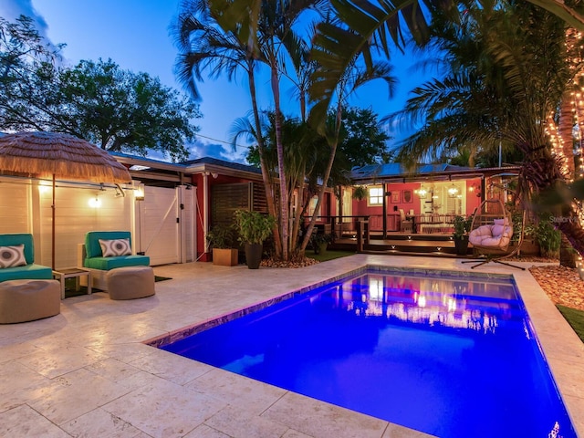 outdoor pool featuring a patio area and a wooden deck