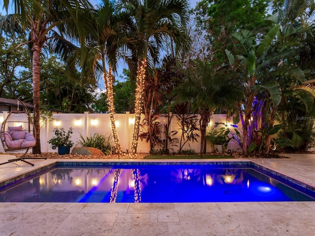 view of swimming pool with a patio area, a fenced backyard, and a fenced in pool