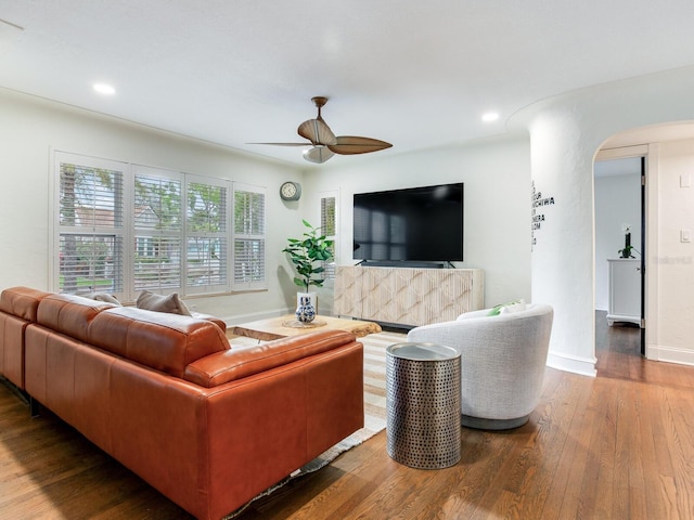 living room with baseboards, ceiling fan, recessed lighting, hardwood / wood-style flooring, and arched walkways