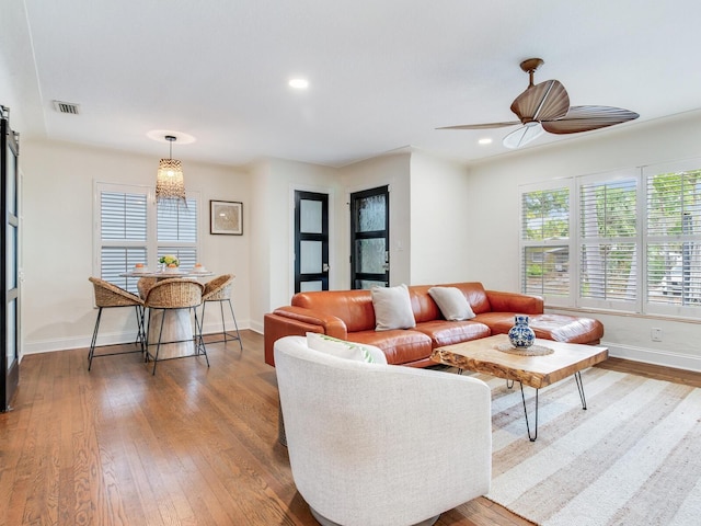 living room featuring visible vents, a healthy amount of sunlight, and hardwood / wood-style floors