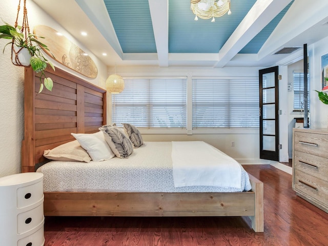 bedroom featuring beamed ceiling, visible vents, dark wood-style flooring, and baseboards