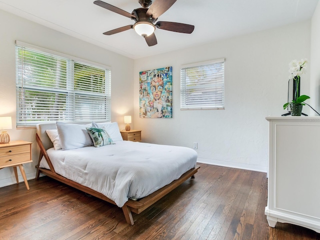 bedroom with ceiling fan, baseboards, and hardwood / wood-style flooring