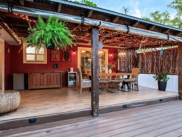 deck with wine cooler and outdoor dining space