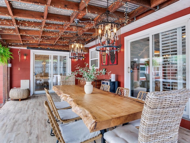 dining area with a chandelier and wood finished floors