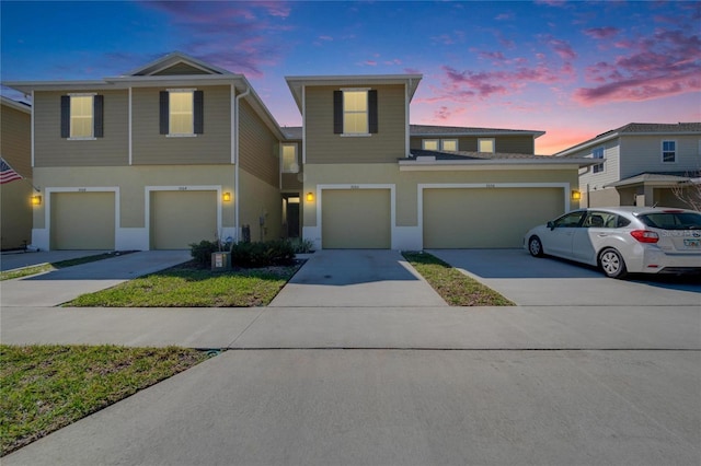 view of front of home with stucco siding and driveway