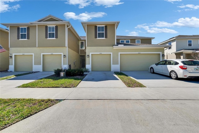 view of front of house with stucco siding and driveway