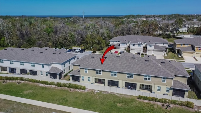 aerial view featuring a wooded view and a residential view