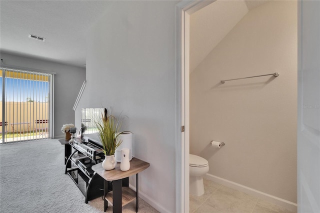 bathroom with baseboards, visible vents, a textured ceiling, tile patterned floors, and toilet