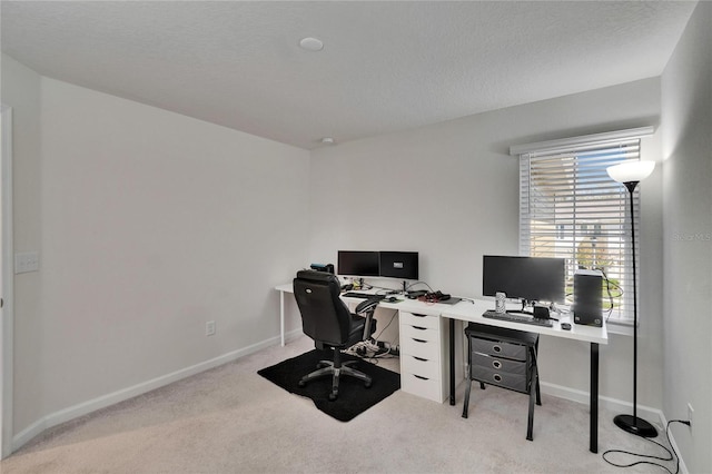 home office featuring baseboards, carpet, and a textured ceiling