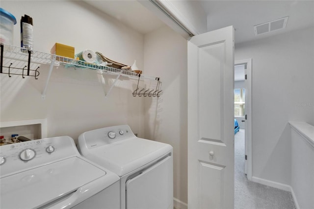 washroom featuring visible vents, independent washer and dryer, carpet floors, baseboards, and laundry area