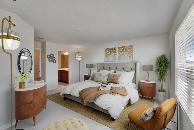 bedroom with visible vents, light carpet, a textured ceiling, and ensuite bathroom