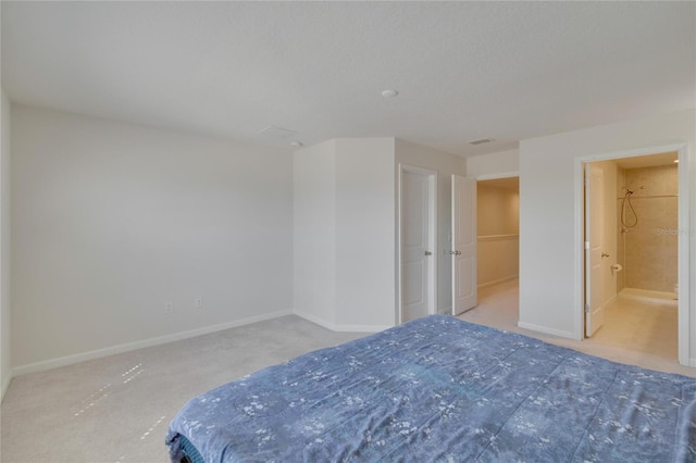 unfurnished bedroom featuring visible vents, baseboards, carpet floors, and ensuite bathroom