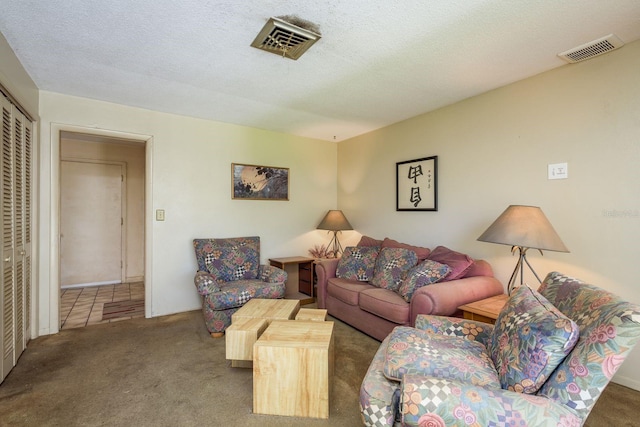 living area featuring visible vents, a textured ceiling, and carpet flooring