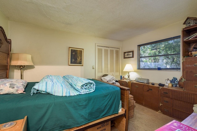 bedroom with light carpet, a textured ceiling, and a closet