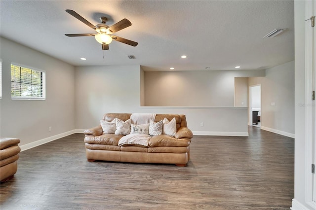 living area with dark wood-type flooring, recessed lighting, visible vents, and baseboards