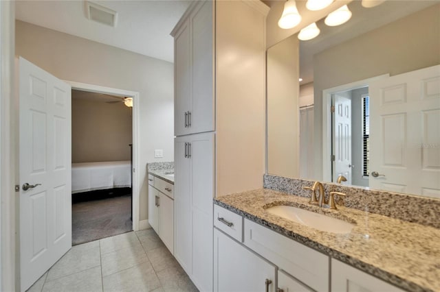 ensuite bathroom featuring tile patterned floors, visible vents, ensuite bathroom, a ceiling fan, and vanity