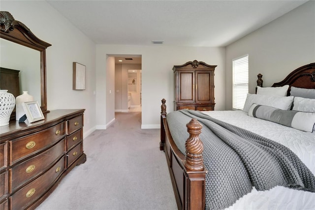 bedroom featuring visible vents, light colored carpet, and baseboards