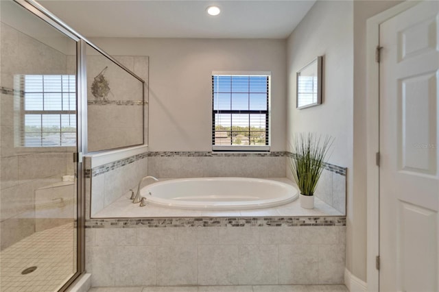 full bathroom with recessed lighting, a garden tub, and a stall shower