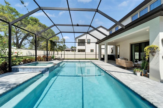 view of swimming pool featuring a patio area, a fenced backyard, glass enclosure, and a pool with connected hot tub