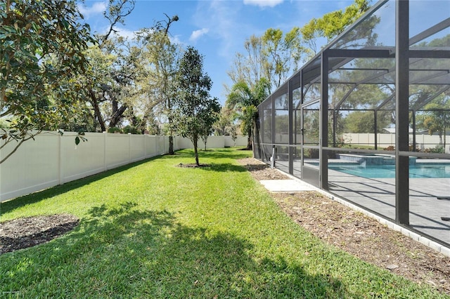 view of yard with glass enclosure, a patio area, a fenced backyard, and a fenced in pool