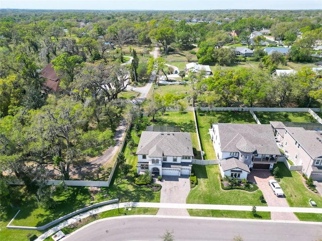 birds eye view of property featuring a forest view and a residential view