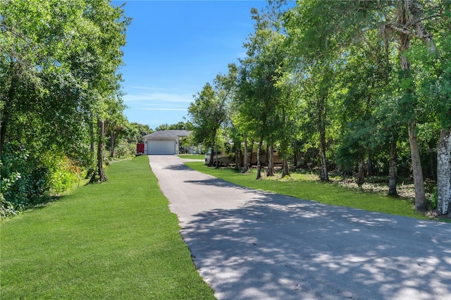 view of front of house with a garage and a front lawn