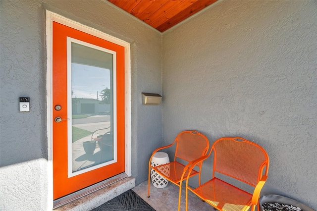 doorway to property featuring stucco siding