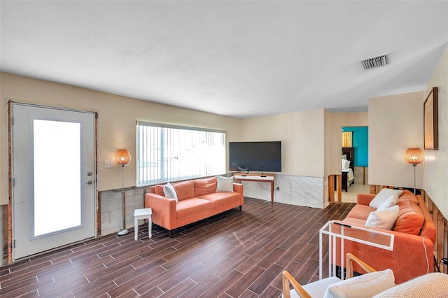 living area with wood finish floors and visible vents