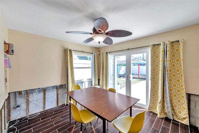 dining room with a ceiling fan, wood tiled floor, and french doors