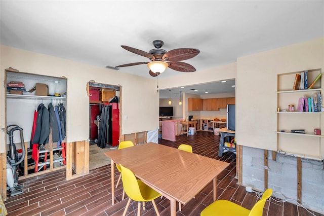 dining room featuring ceiling fan, visible vents, and wood finish floors