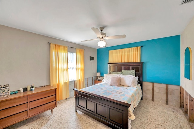 bedroom featuring speckled floor, visible vents, and a ceiling fan