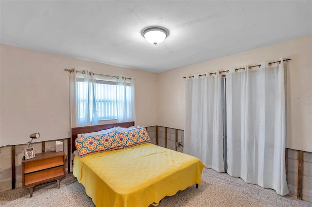 bedroom with light speckled floor