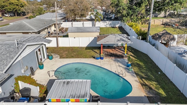 view of pool with a patio, a yard, a fenced backyard, and a fenced in pool