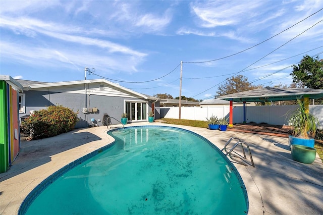 view of swimming pool with a patio area, a fenced backyard, and a fenced in pool