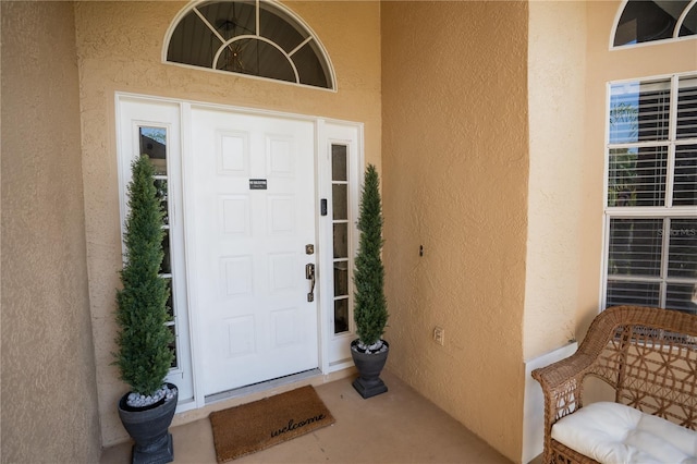 view of exterior entry featuring stucco siding