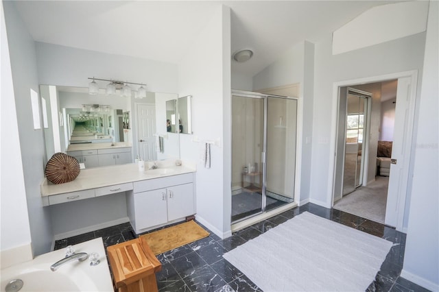 full bathroom featuring baseboards, lofted ceiling, vanity, and a shower stall