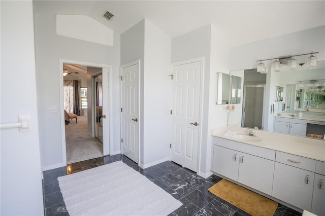 full bath featuring visible vents, baseboards, lofted ceiling, a stall shower, and ensuite bathroom