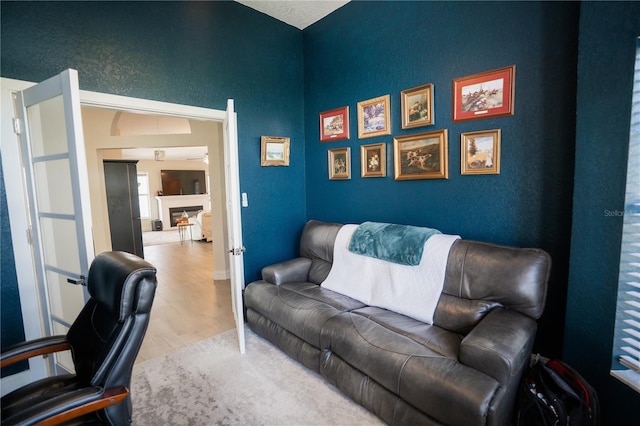 office space featuring a fireplace and wood finished floors