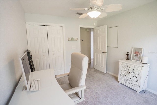 home office featuring ceiling fan, baseboards, visible vents, and light carpet