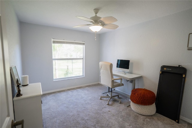 carpeted home office with baseboards and a ceiling fan