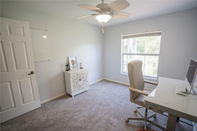 carpeted office with baseboards and ceiling fan