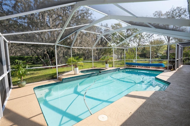 view of swimming pool with glass enclosure, a lawn, a pool with connected hot tub, and a patio area