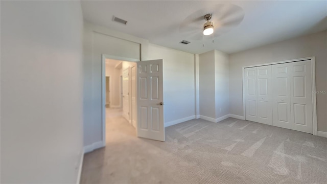 unfurnished bedroom with light carpet, visible vents, and baseboards