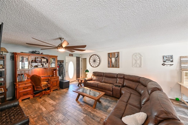 living area with a ceiling fan, a textured ceiling, and wood finished floors